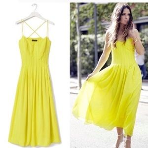 Vibrant midi pintuck dress in chartreuse with pockets.